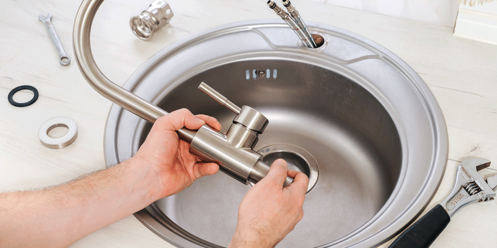 mans hands fixing faucet | plumbing service jacksonville fl callahan fl