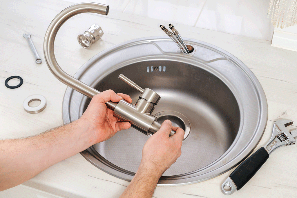 mans hands fixing faucet | plumbing service jacksonville fl callahan fl