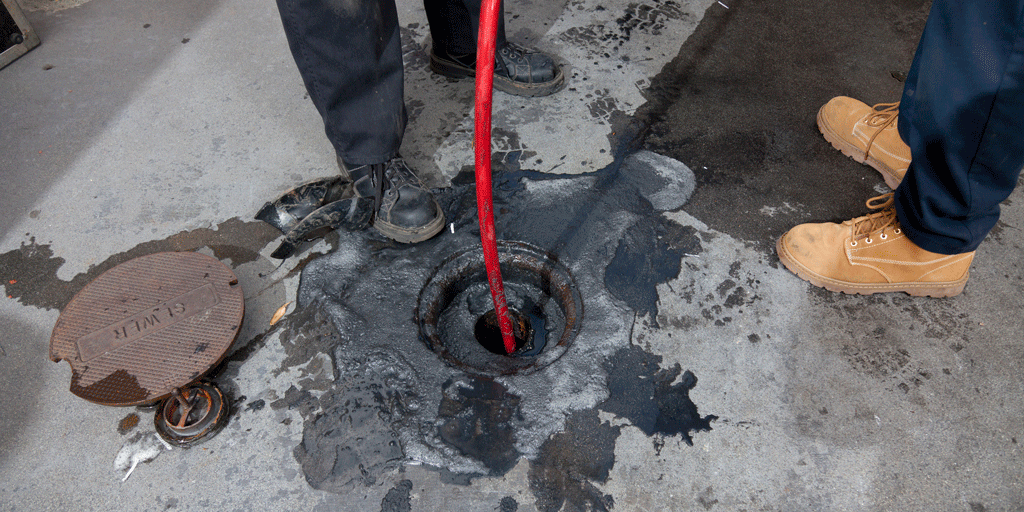 two mens boots cleaning sewer on a street sewer line jetting callahan fl jacksonville fl
